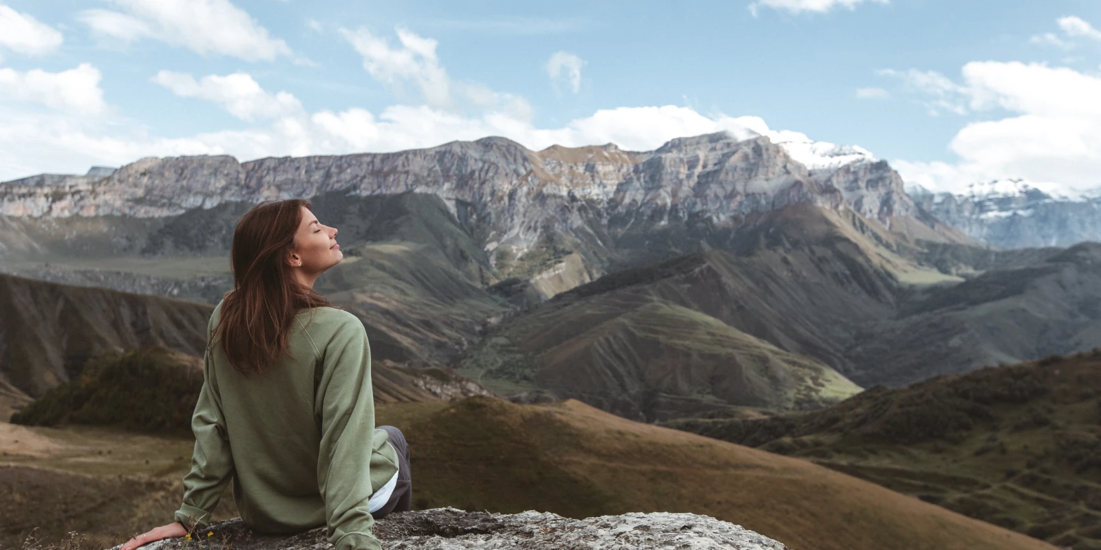 Confident woman breathing calmly after practising her breathing techniques.
