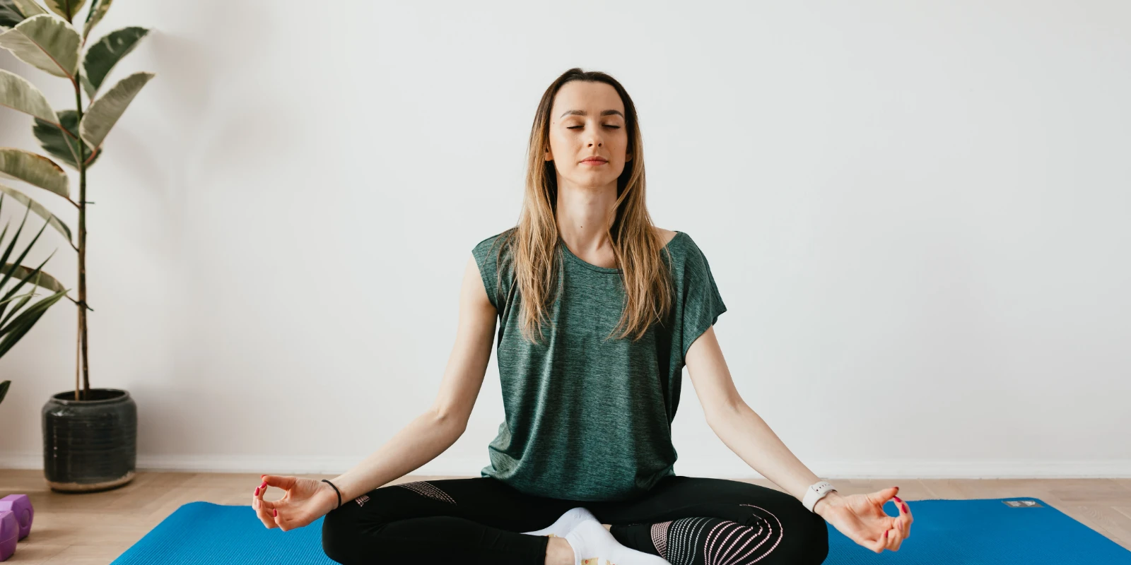 Woman sitting peacefully while practising breathing techniques to manage her breathing.
