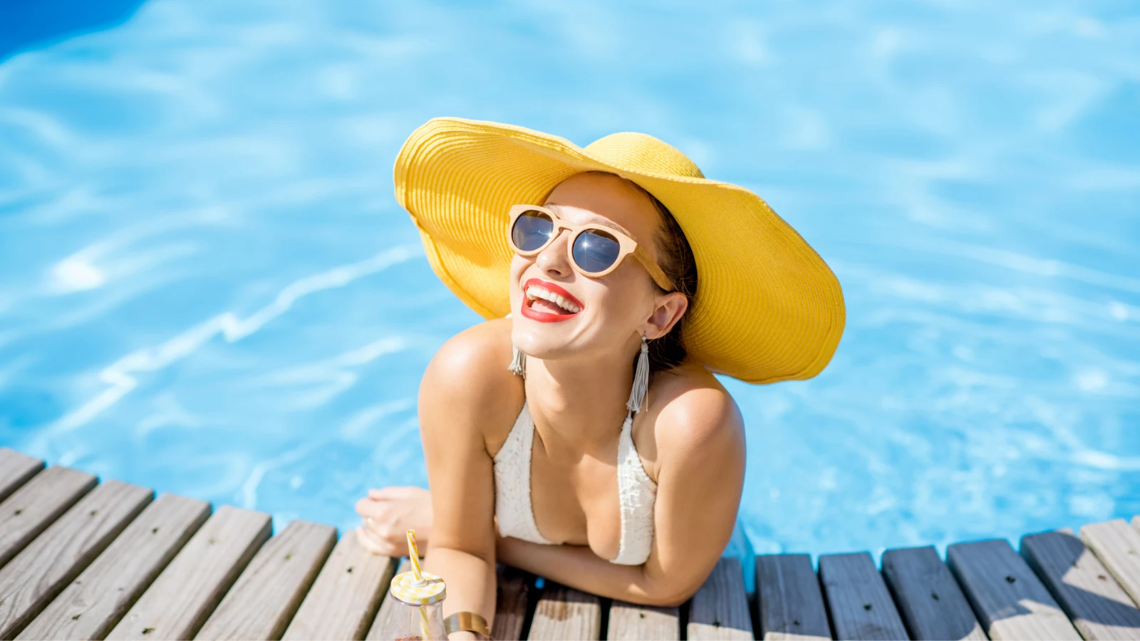 Woman resting at the edge of a swimming pool after swimming