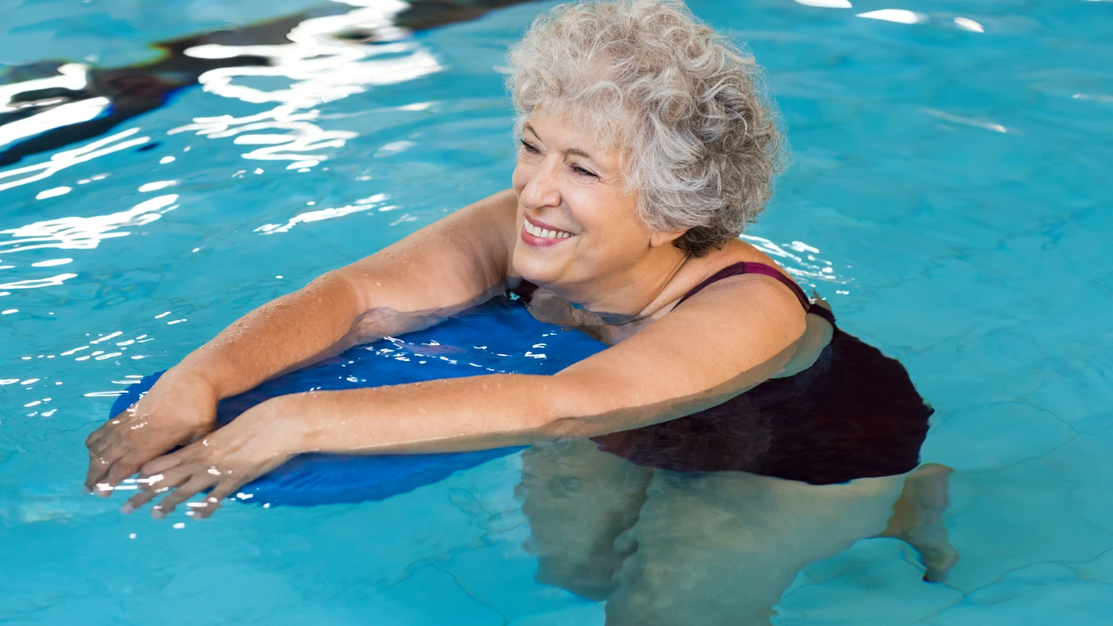 Woman performing gentle exercise in a swimming pool