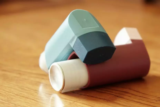 Two inhalers placed on a wooden surface, used for managing COPD symptoms.