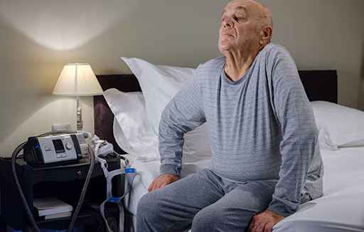 Elderly man with COPD using a CPAP machine at night to support his breathing.