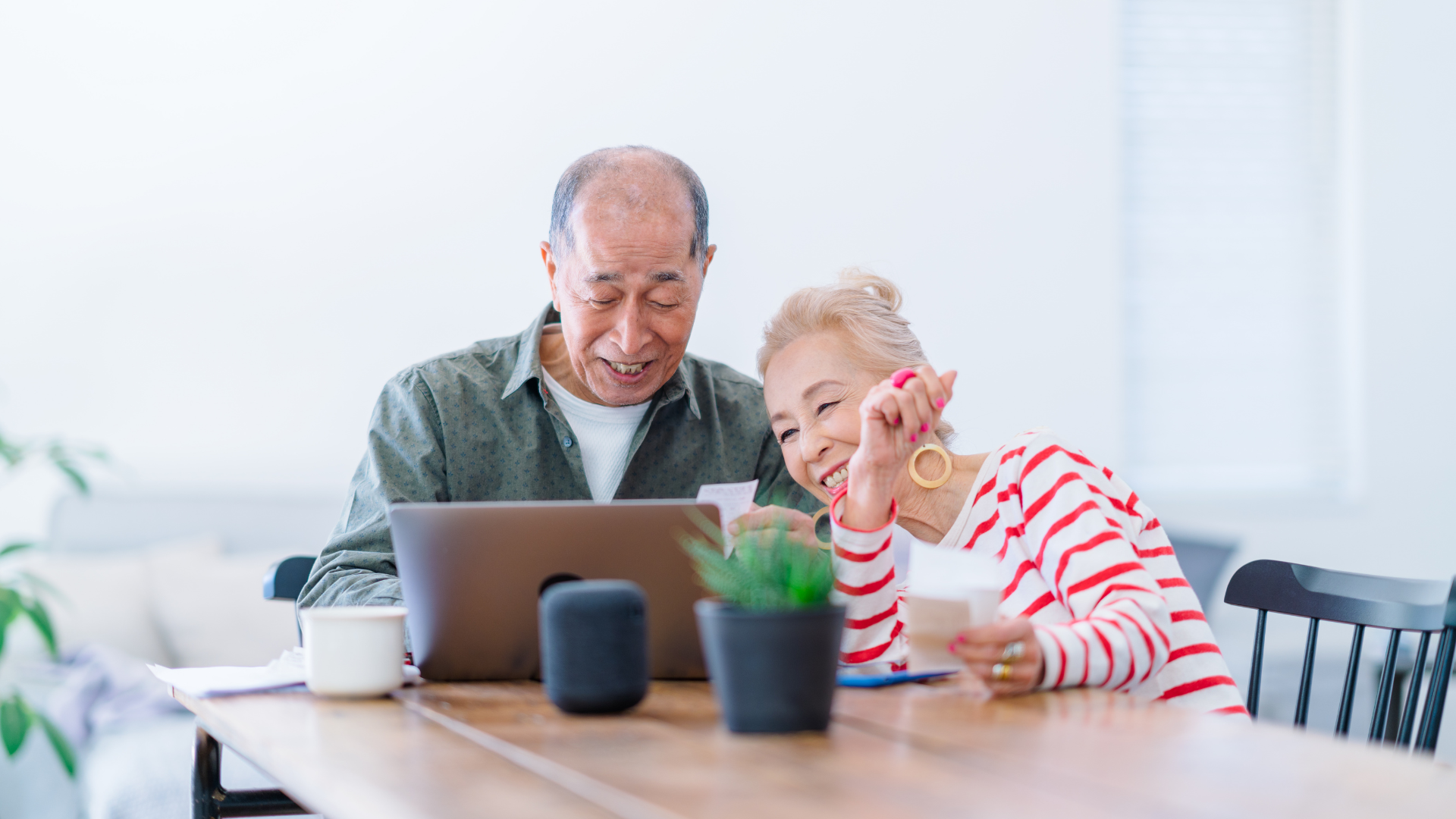Senior couple reviewing COPD treatment information on a computer while managing their health together.