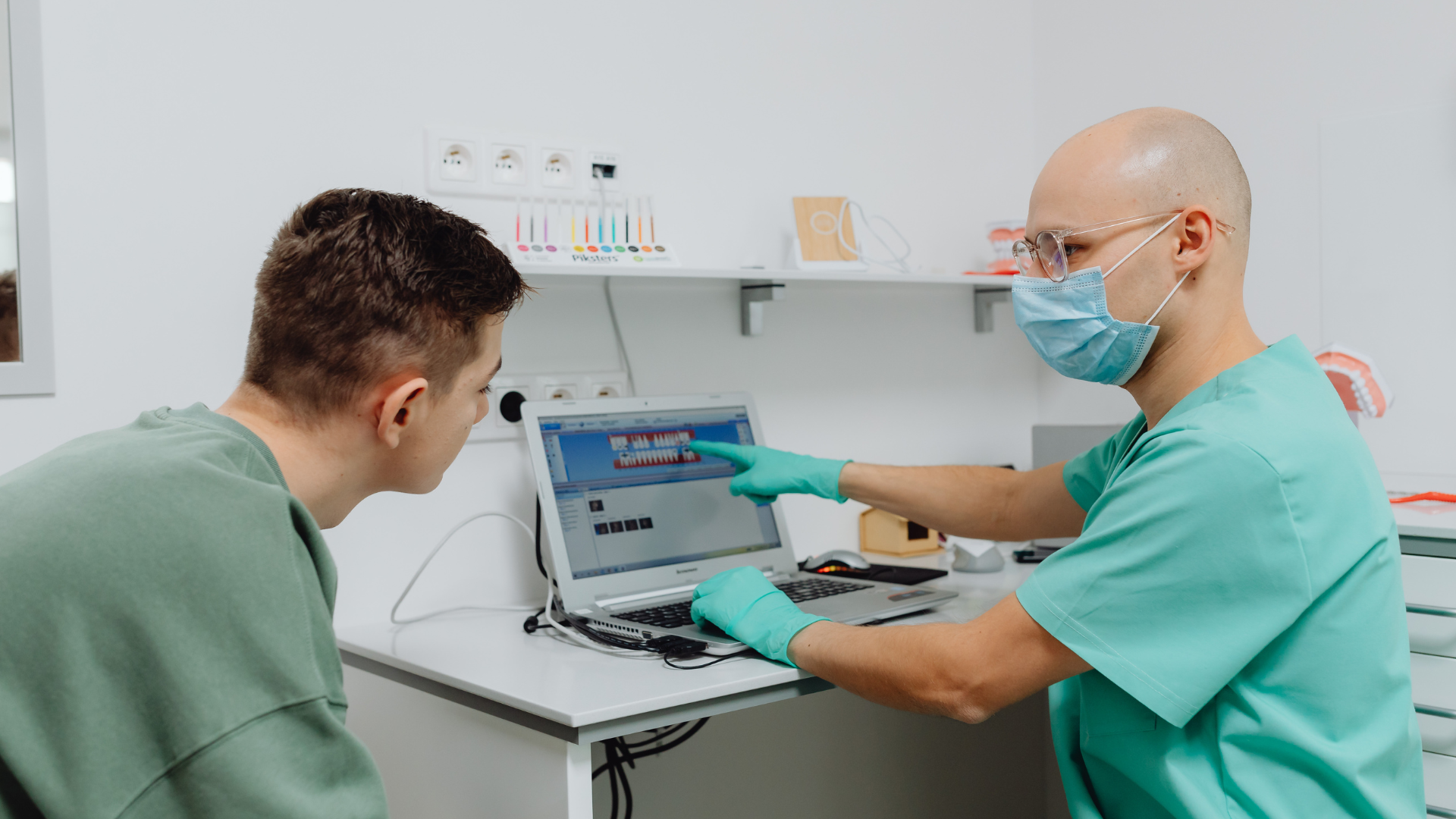 Adult reviewing screening information with a doctor before a lung health check.