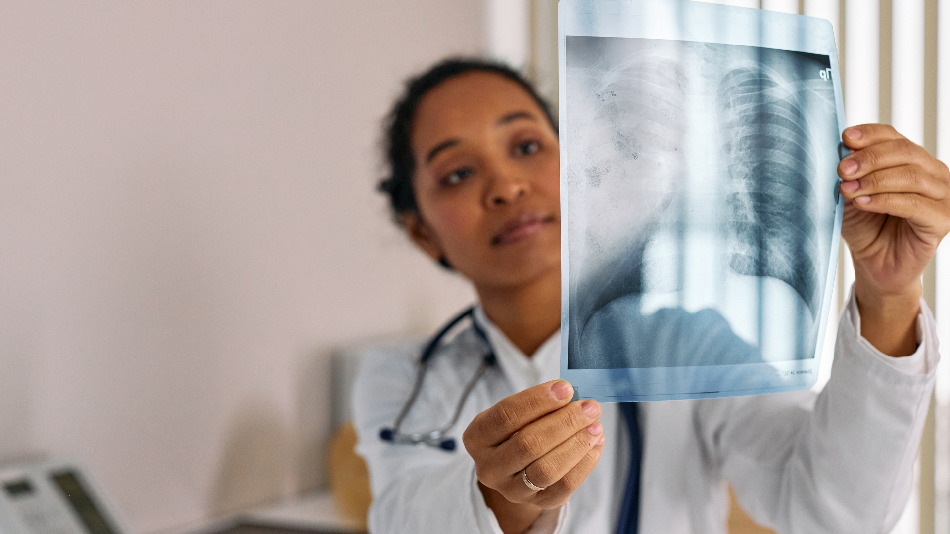Adult reviewing early detection information with a doctor during a lung health consultation.