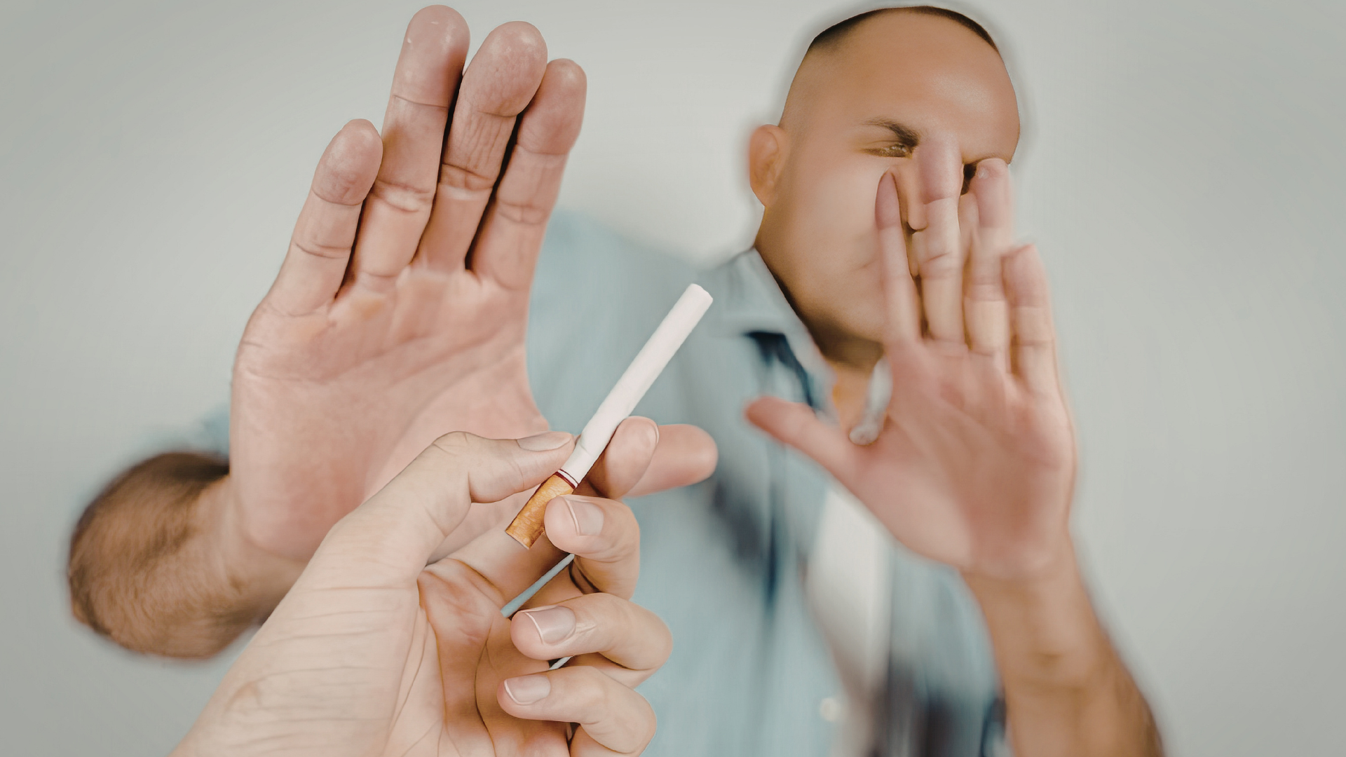 Person refusing a cigarette while trying to quit smoking.