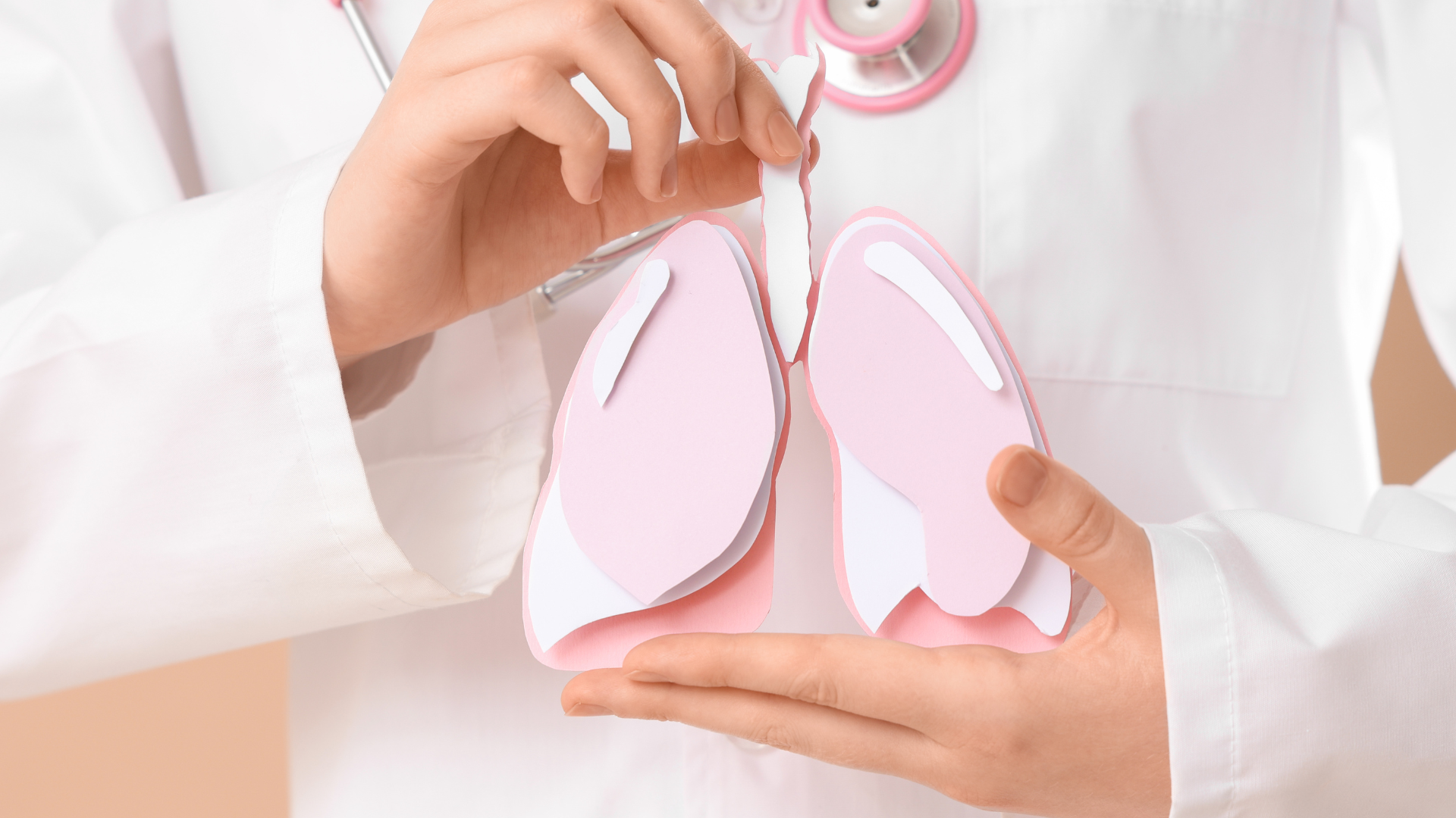 Doctor holding a paper lung model during a discussion about lung health.