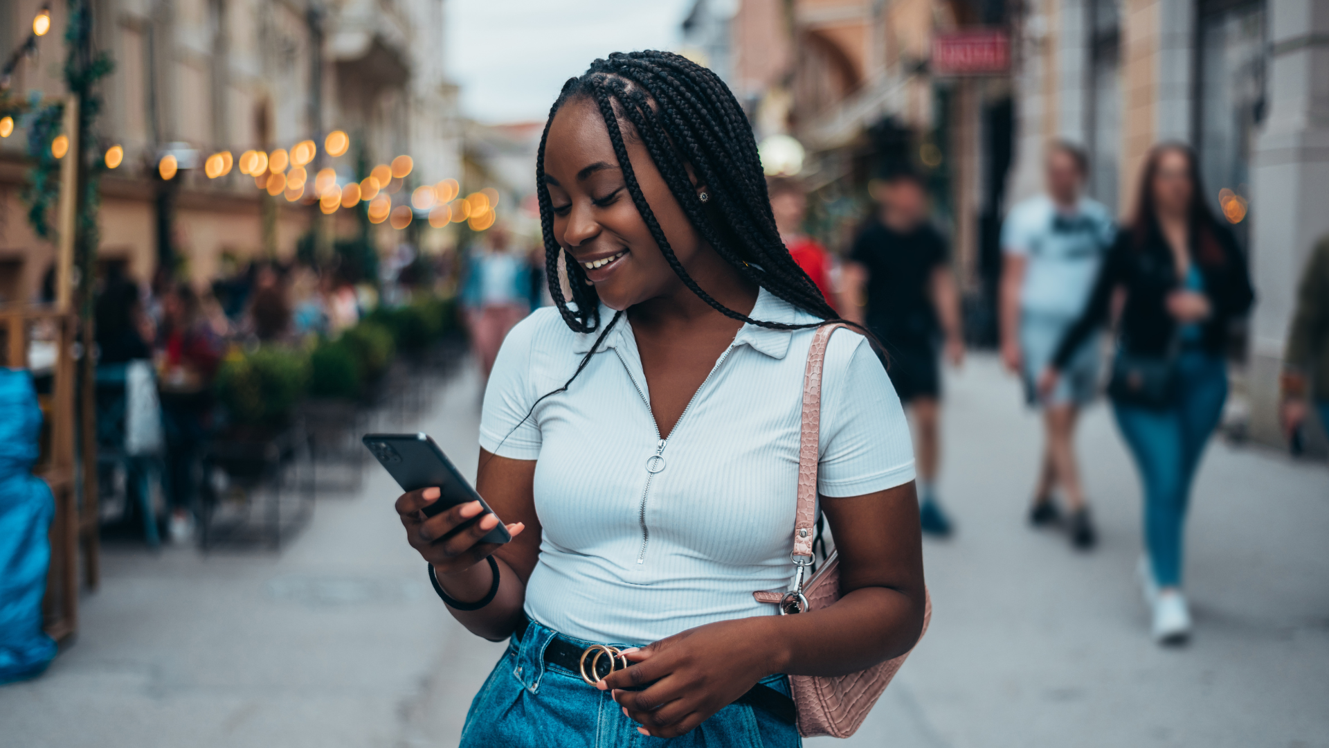 Person checking pollen levels on smartphone while managing asthma outdoors