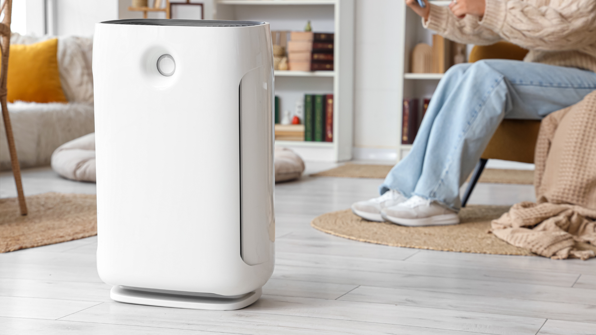 Person reducing pollen at home with an air purifier.